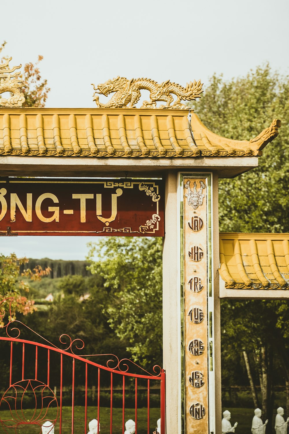 a red and white gate with a dragon on it