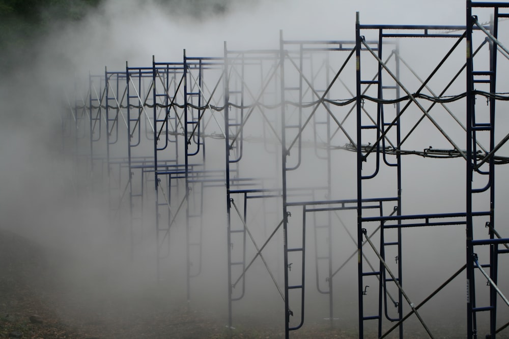a row of metal scaffoldings in the fog