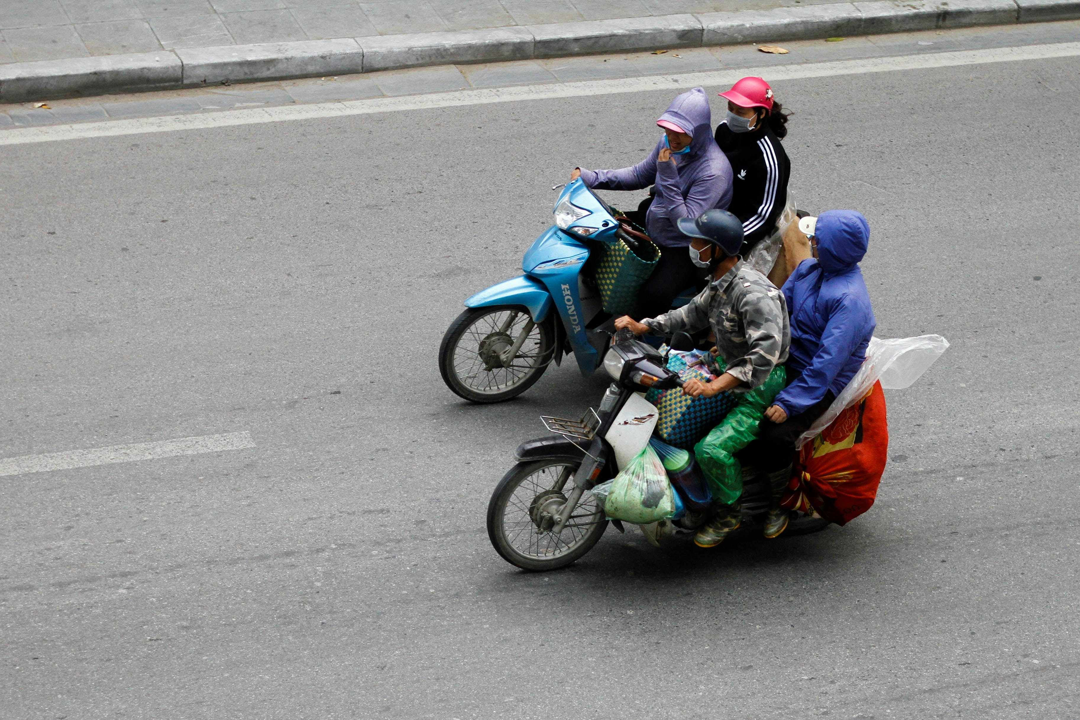 a group of people riding on the back of a motorcycle