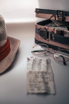 Close-up of a vintage suitcase with musical notes spilling out.