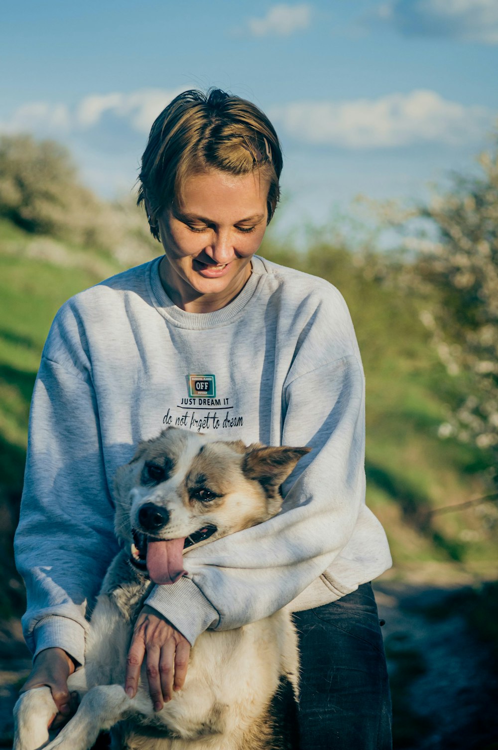 a woman holding a dog in her arms