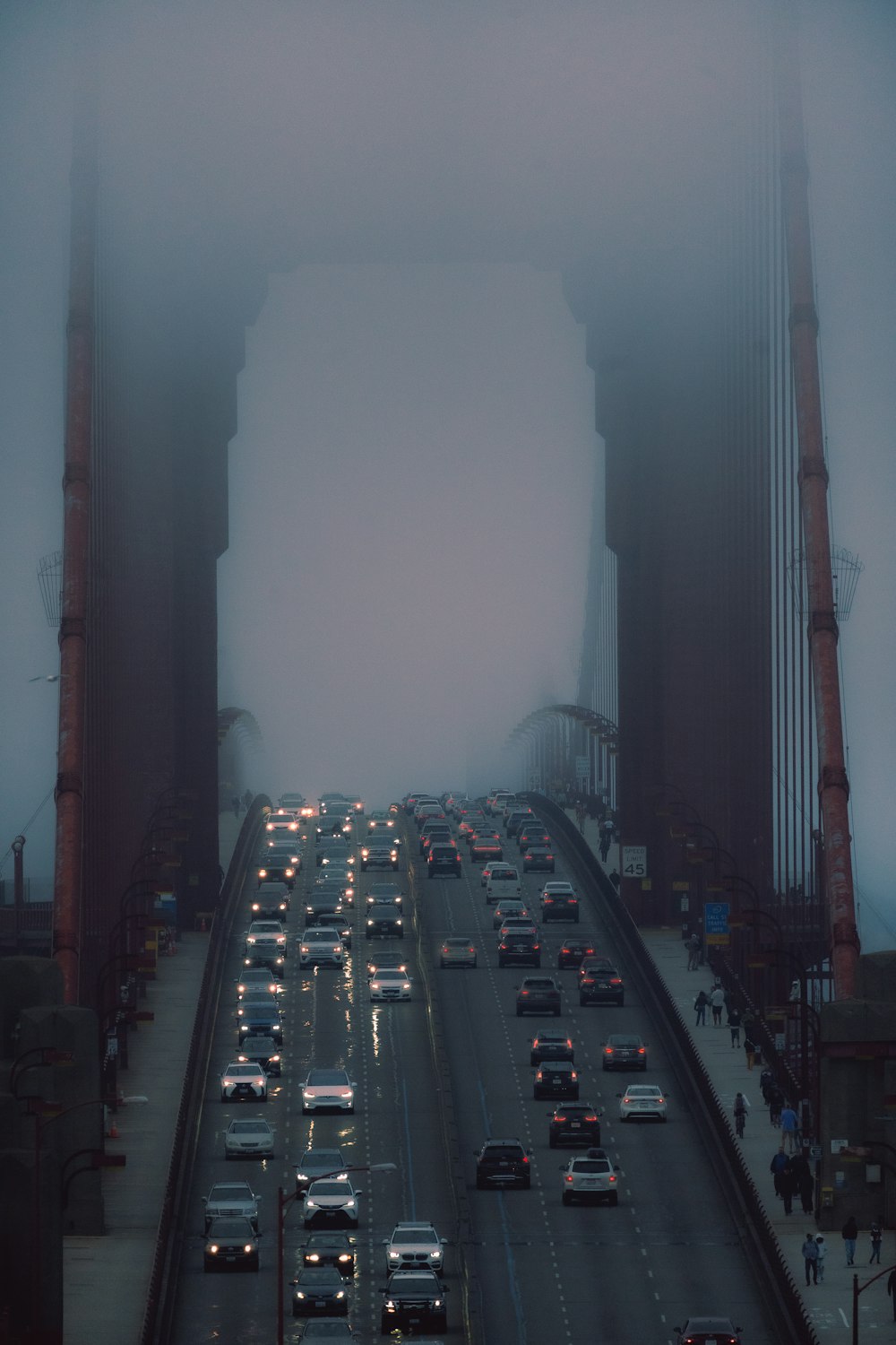 a foggy city street filled with lots of traffic