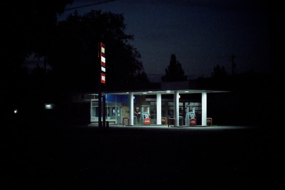 a gas station at night with the lights on