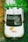 A white vehicle with a company logo on the hood has a ginger cat resting on it. Above the vehicle, green vines hang down. The surrounding ground is covered with small white flowers and greenery.