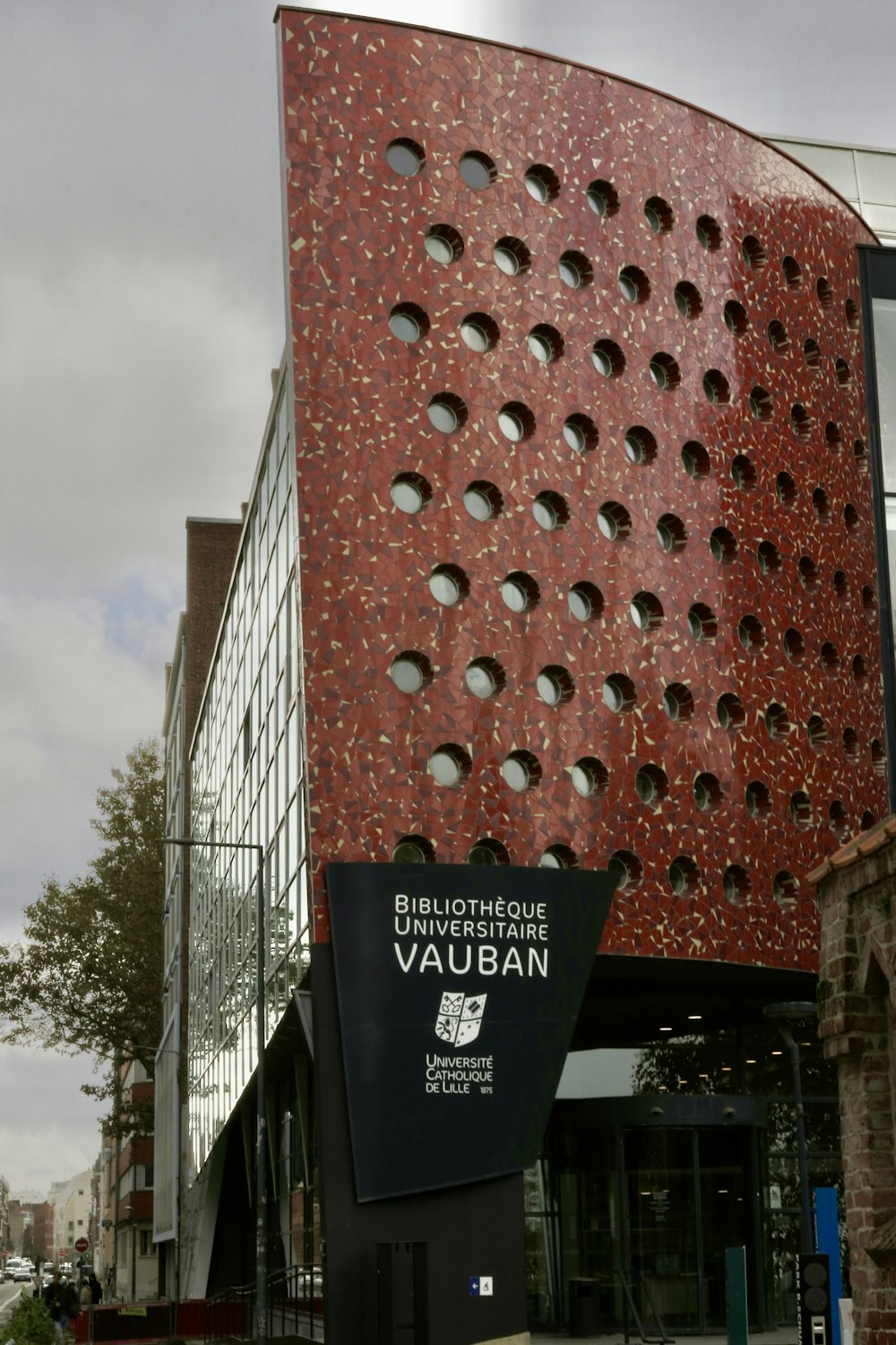 a red building with holes in the side of it