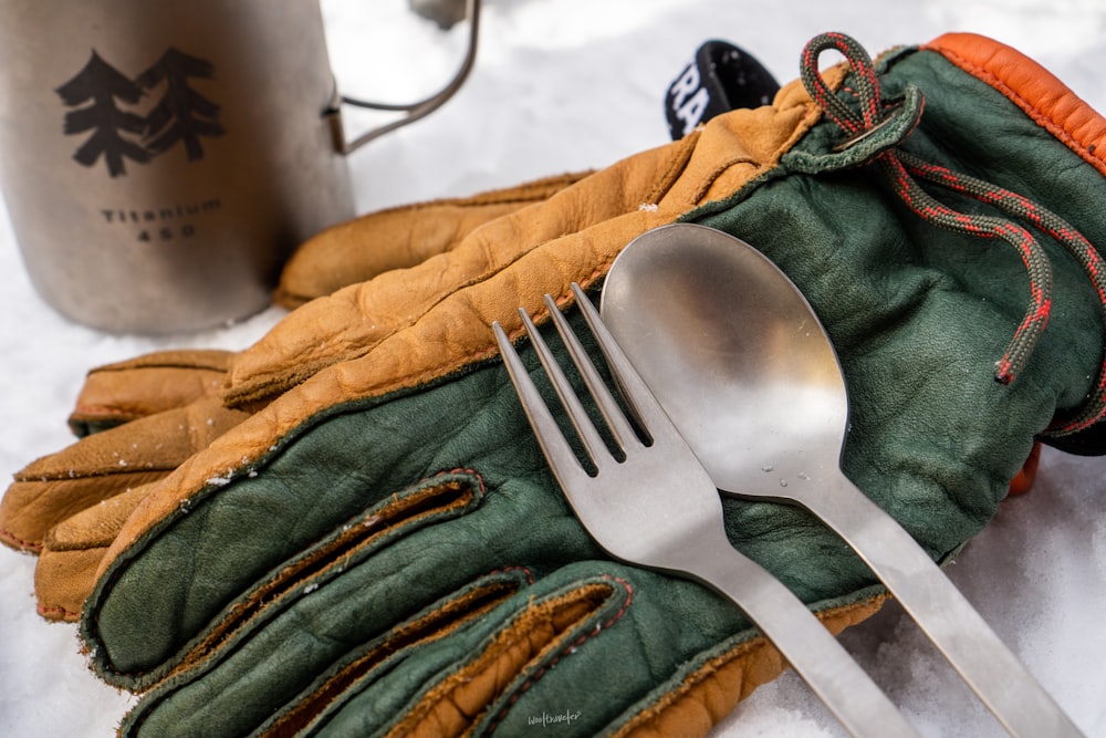 a pair of gloves and a fork on a table