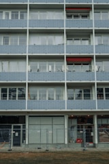 Wide shot showing multiple balconies fitted with safety nets in a residential complex.