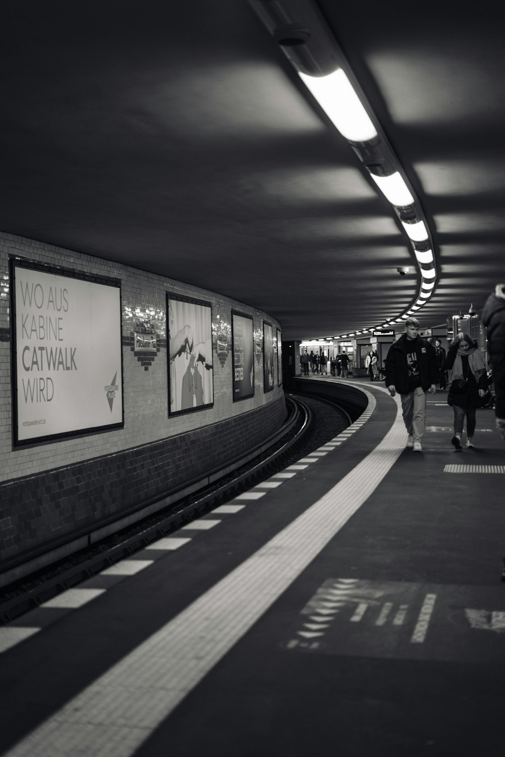 a black and white photo of a subway station