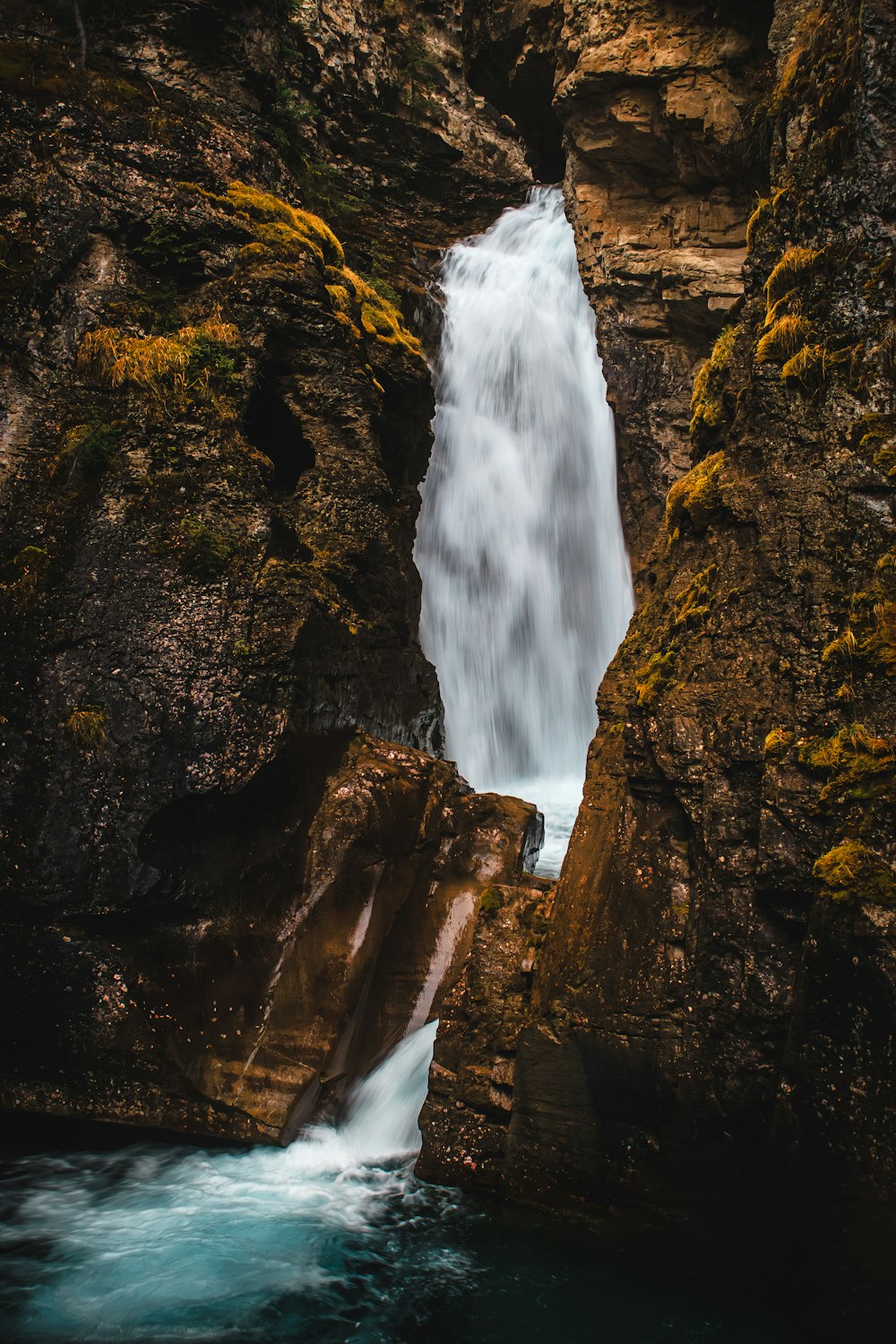 a small waterfall in the middle of some rocks