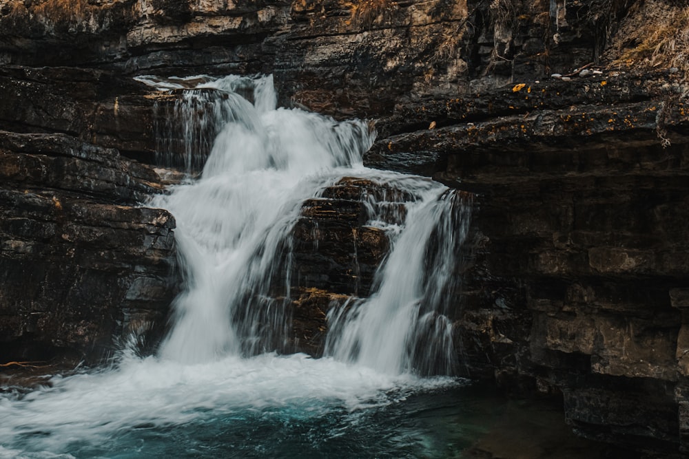 a waterfall with water cascading down it's sides