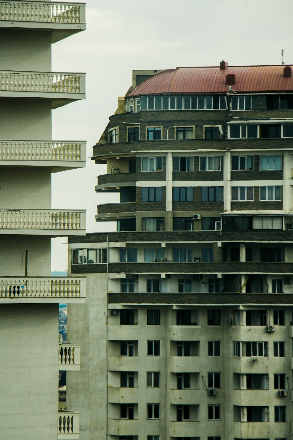 a tall building with balconies on top of it