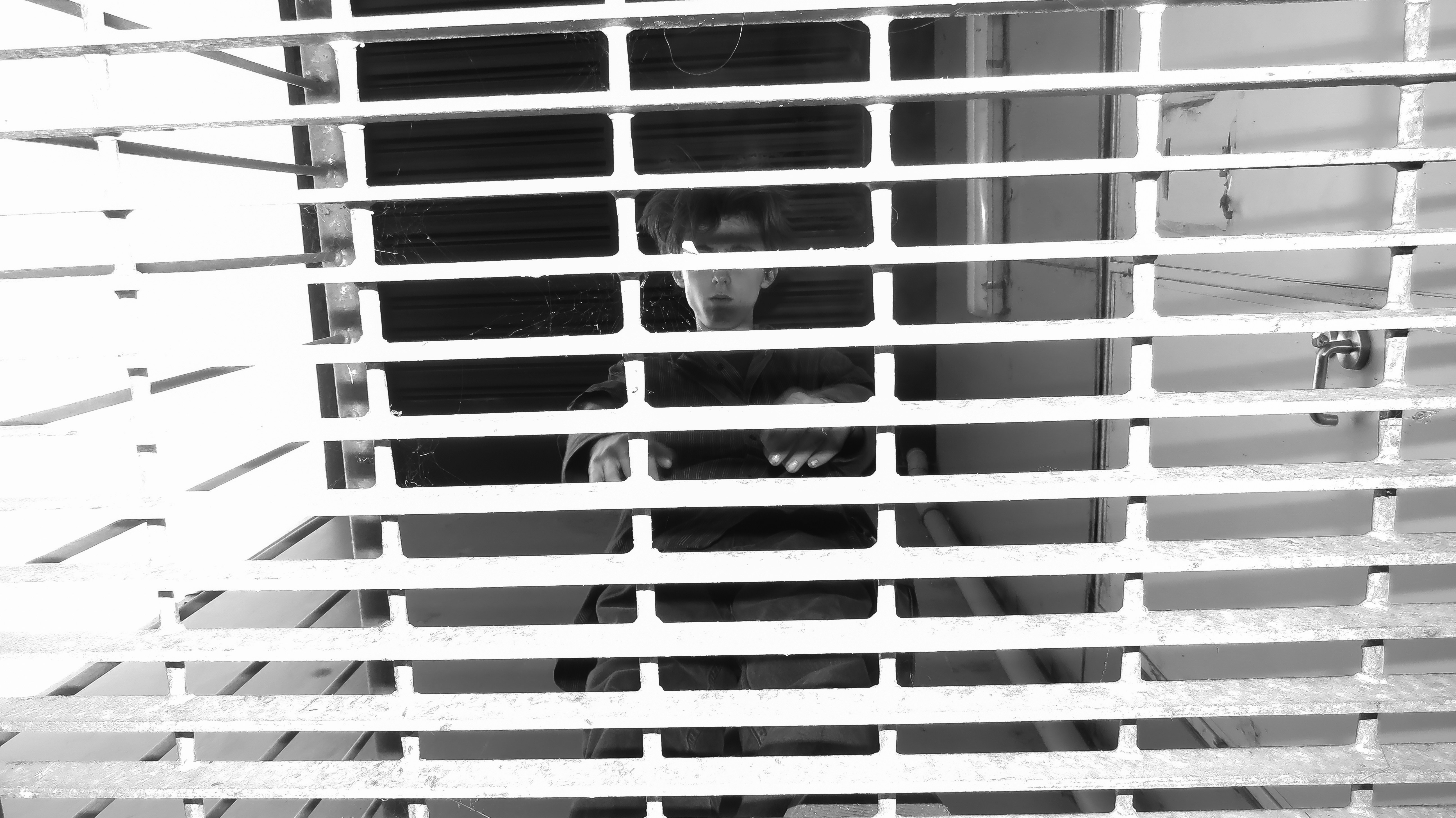 a person standing behind bars in a window