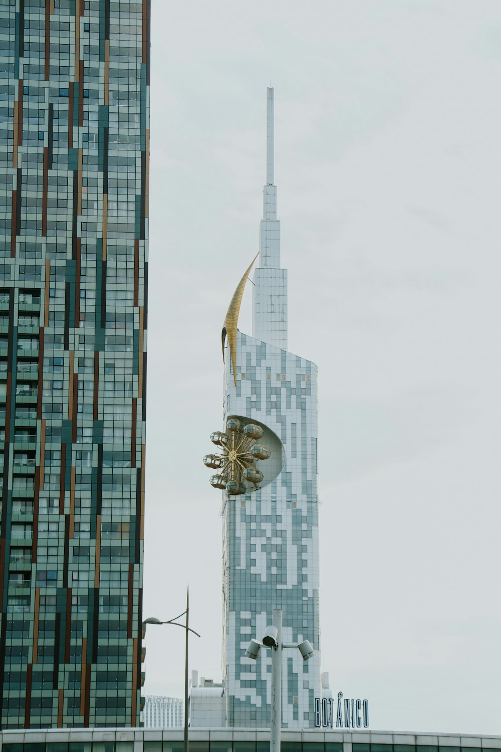 a tall building next to a very tall building