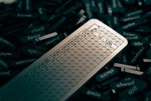 A sleek laptop screen displaying the scramblio word unscrambler interface with colorful letter tiles.