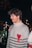 a young man wearing a sweater with a heart on it
