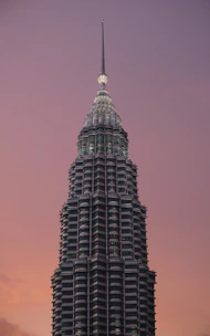 A stunning exterior shot of the BPTP Skynest twin towers piercing the sky at sunset.