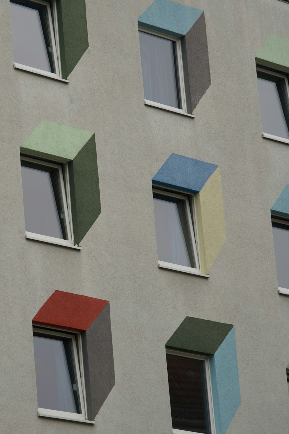 a multicolored building with several open windows