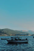 Friends taking a boat ride on a calm, crystal-clear lake.
