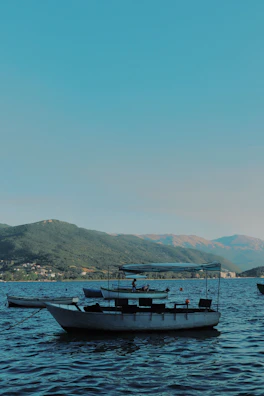 Friends taking a boat ride on a calm, crystal-clear lake.