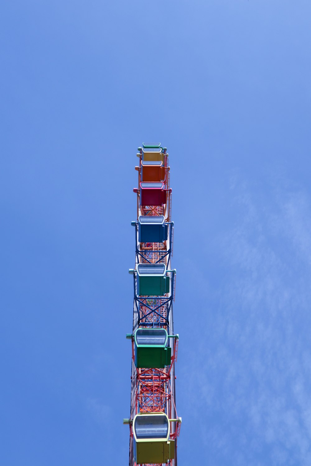 a colorful ferris wheel against a blue sky