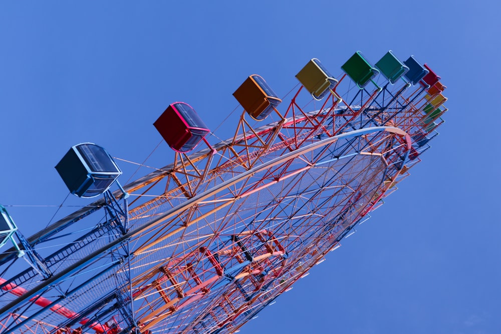 a colorful ferris wheel against a blue sky
