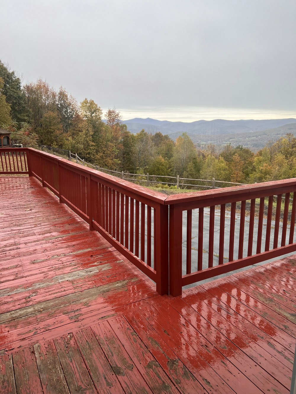 a wooden deck with red paint on it