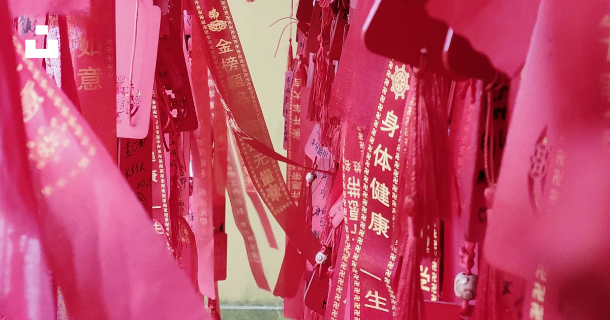A bunch of pink ribbons hanging from a ceiling photo – Free Mobile ...