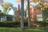 Charming exterior of a New England cottage with autumn foliage.
