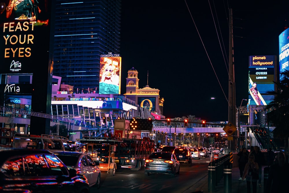 a city street filled with lots of traffic at night