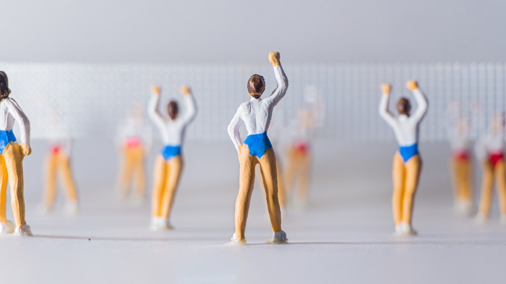 a group of figurines that are standing in front of a wall