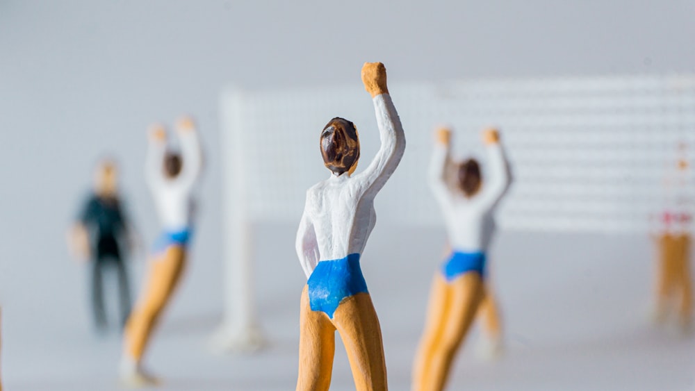 a close up of a figurine of a person holding a tennis racket