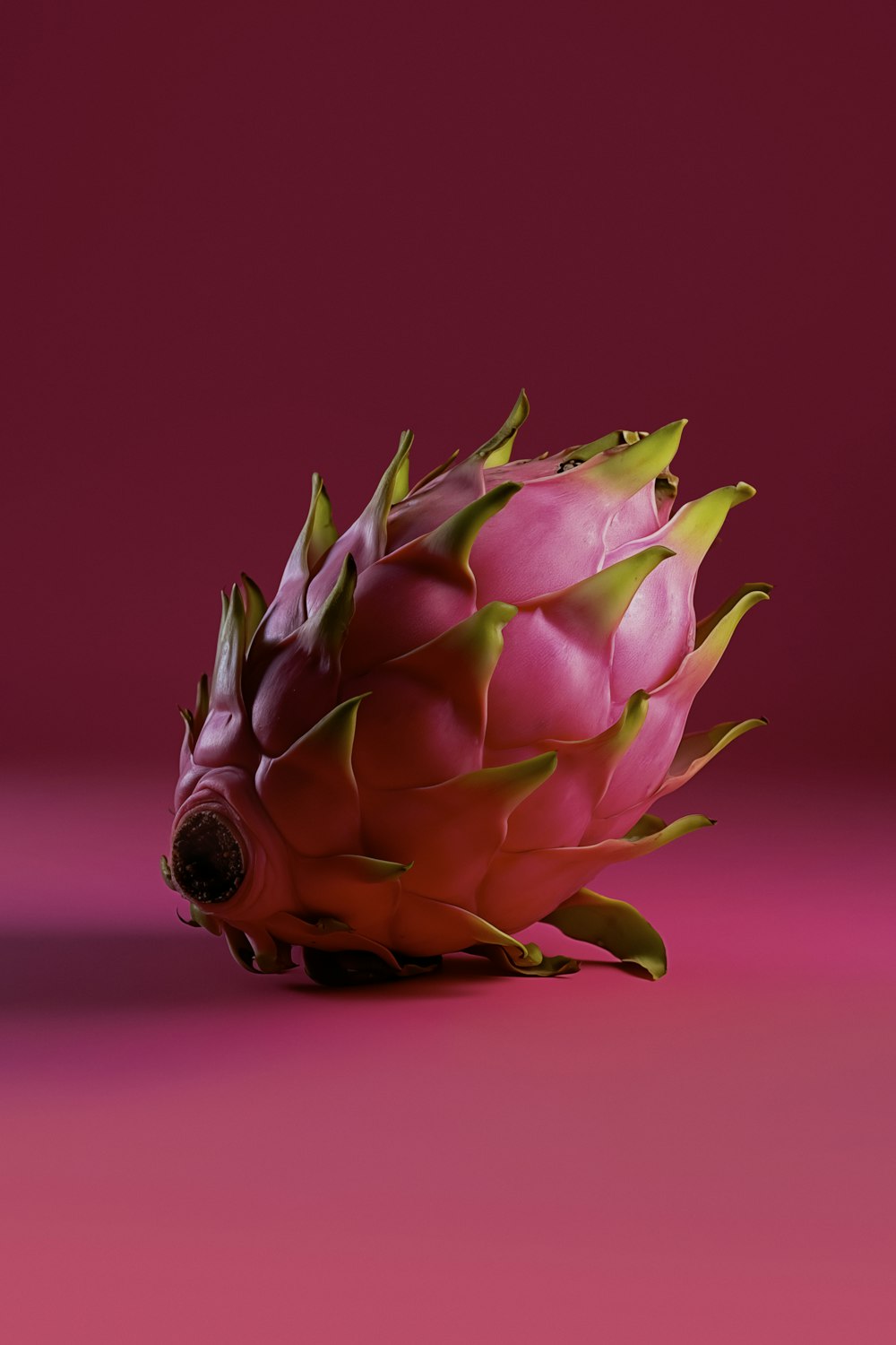 a close up of a fruit on a pink background