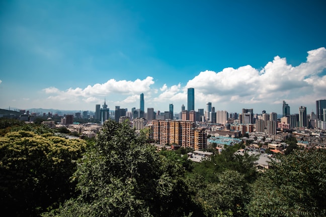 A vibrant city skyline showcasing modern architecture and greenery.