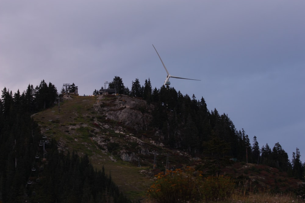 a wind turbine on top of a hill