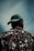 a man wearing a green hat looking up into the sky