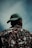 a man wearing a green hat looking up into the sky