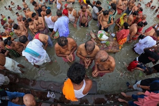 A vibrant crowd of devotees taking a holy dip in the flowing Godavari river during the festival.
