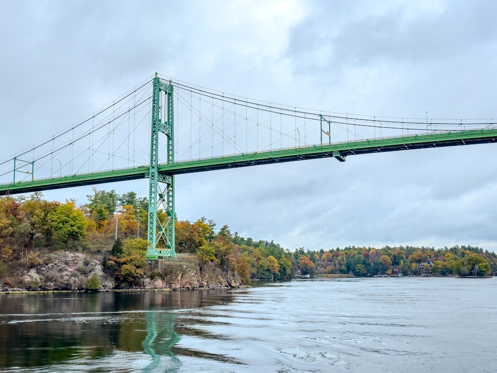 a green bridge over a body of water