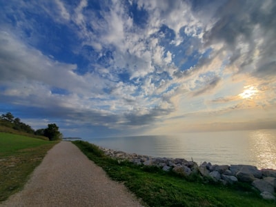 A serene coastal path bathed in golden light, inviting a slow, mindful walk.
