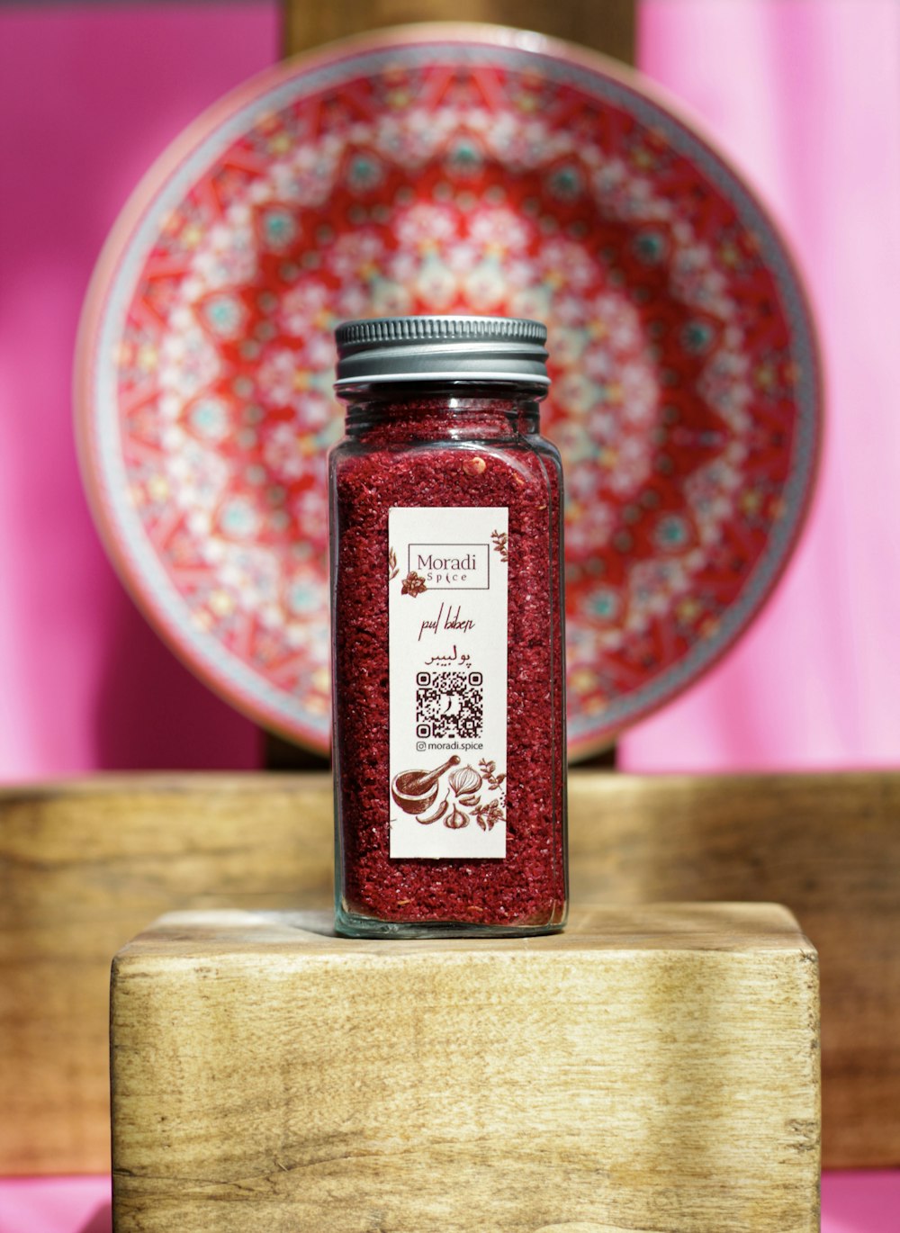 a jar of jam sitting on top of a wooden table