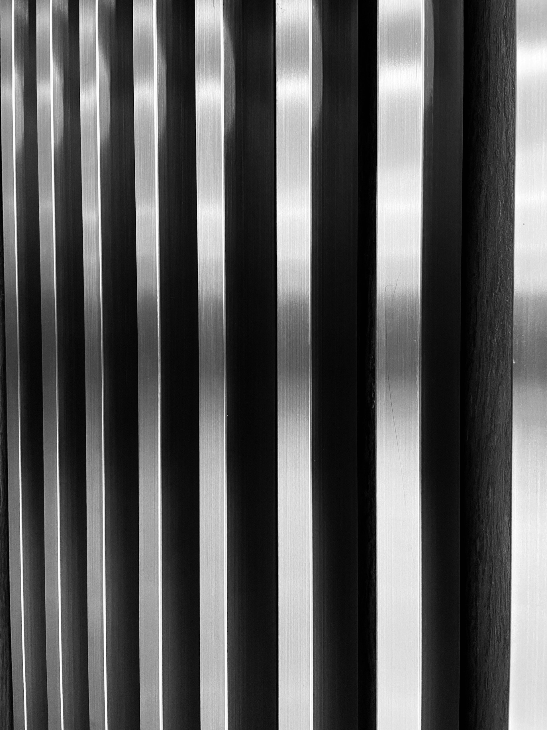 a black and white photo of a metal wall