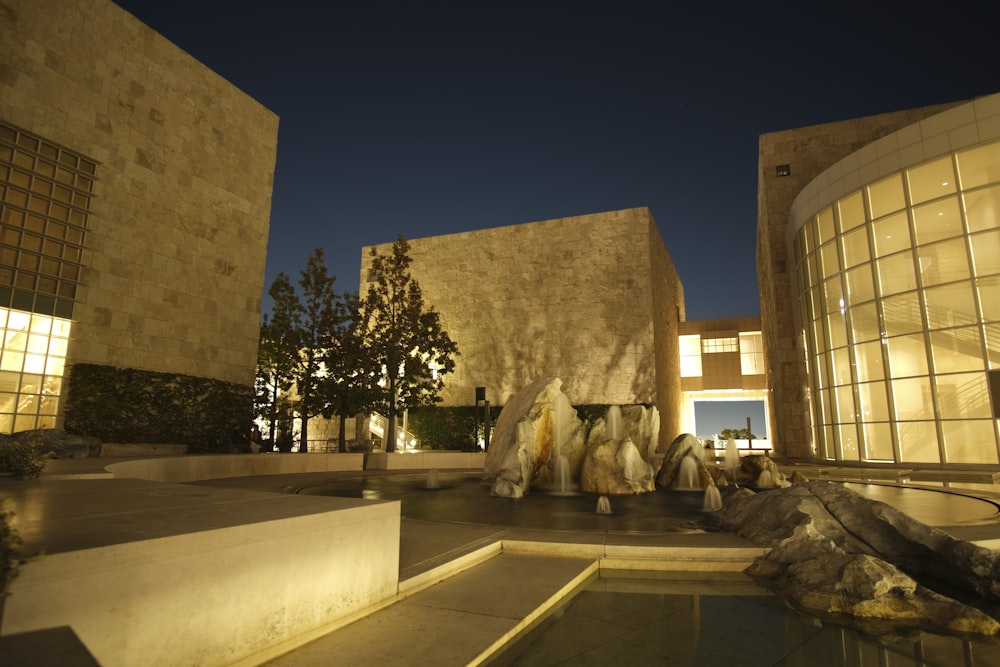 a building with a fountain in front of it at night