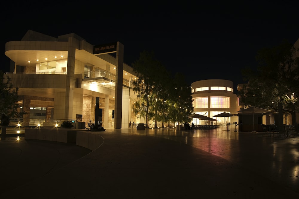 a building lit up at night with lights on