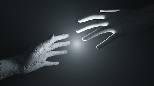 A stone-textured human hand reaches out towards a robotic hand with an illuminated point between them, set against a dark and minimalistic background.