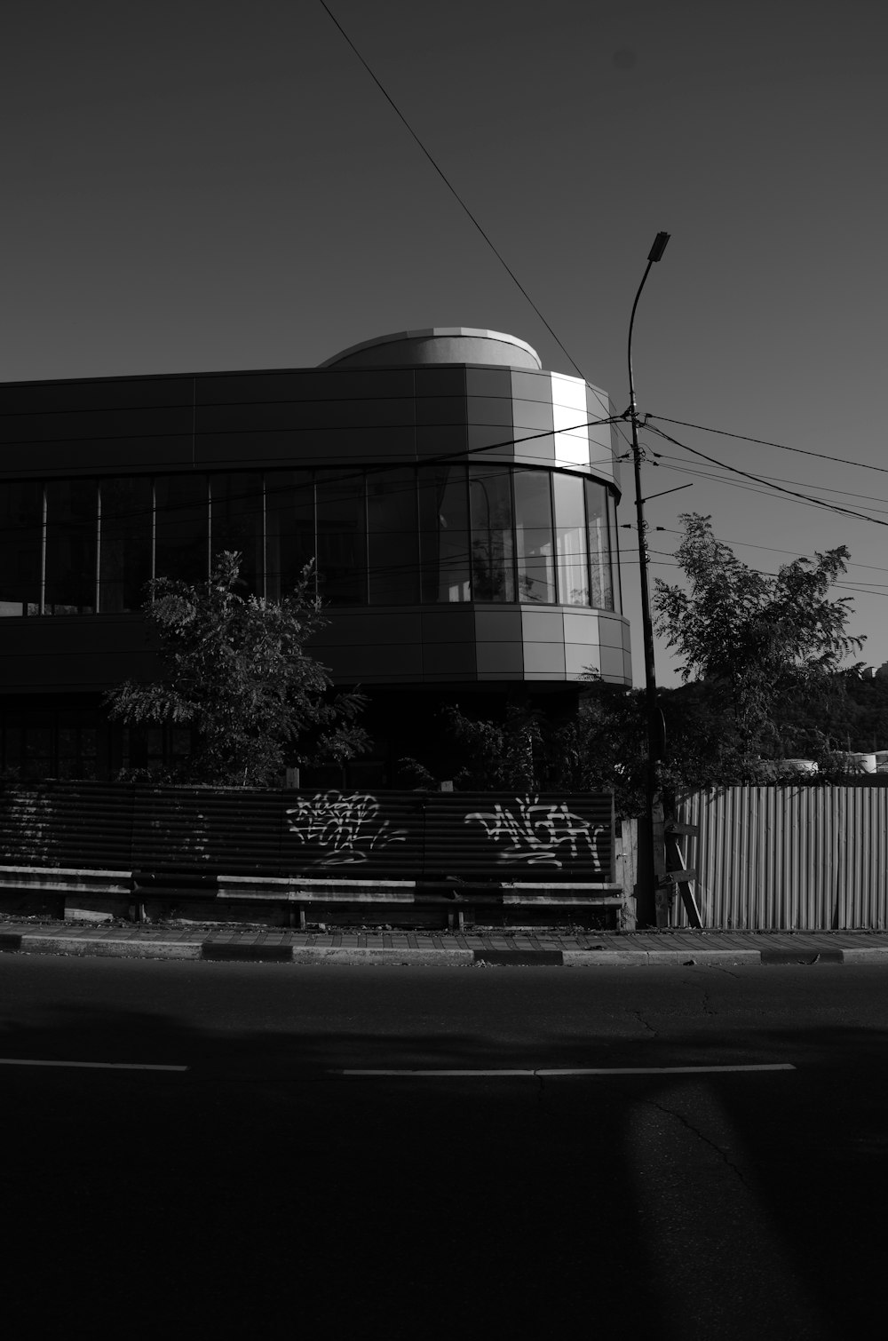 a black and white photo of a building with graffiti on it