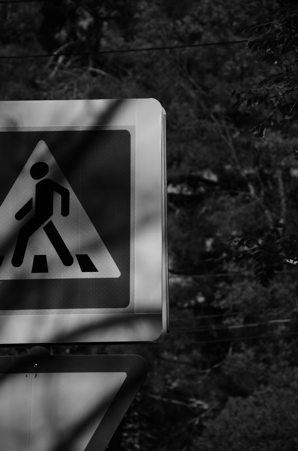 Una foto en blanco y negro de una señal de paso de peatones