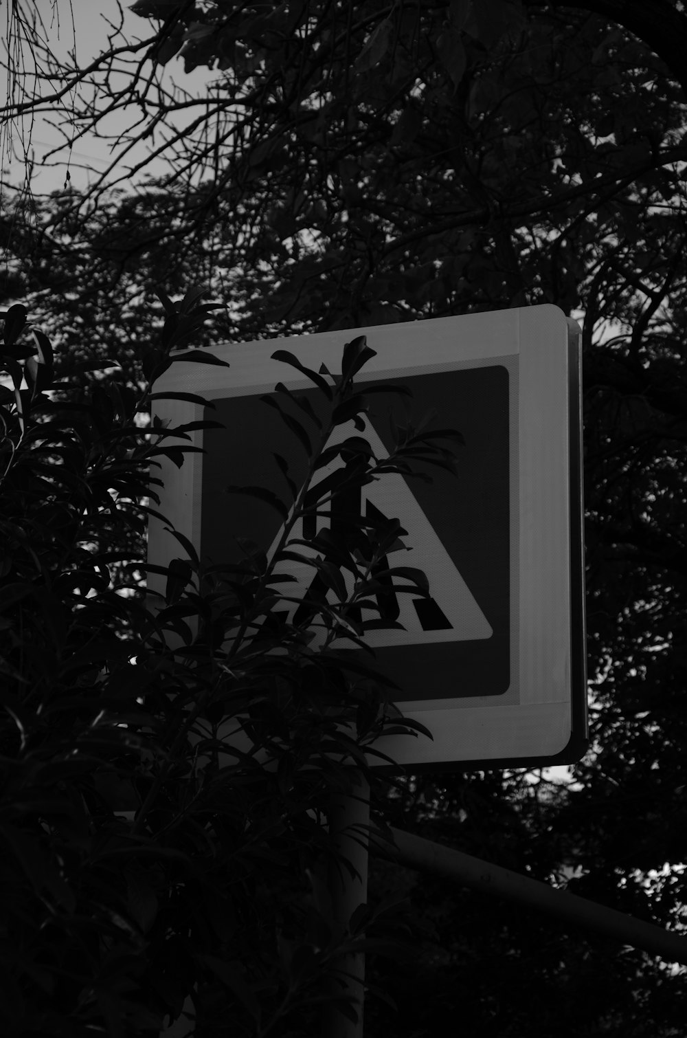 a black and white photo of a street sign