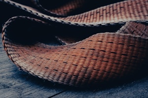 Close-up of handcrafted natural fiber women's handbag on rustic table