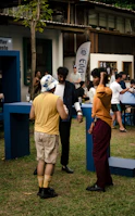 A community gathering outdoors near an ecological water system designed for climate resilience.