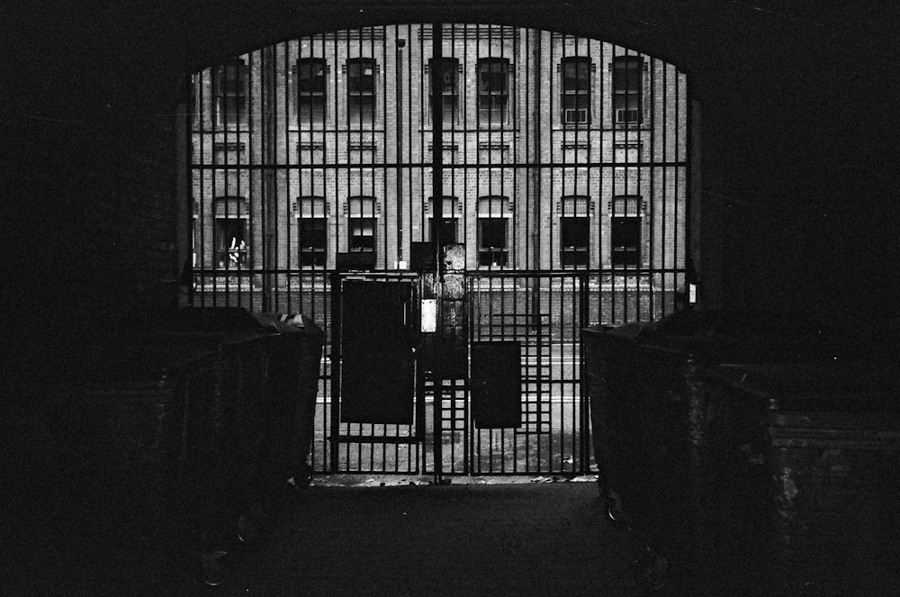 a black and white photo of a jail cell